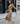 DressUp camel long sleeve wrap midi dress with side ring detail worn by a woman on a city street
